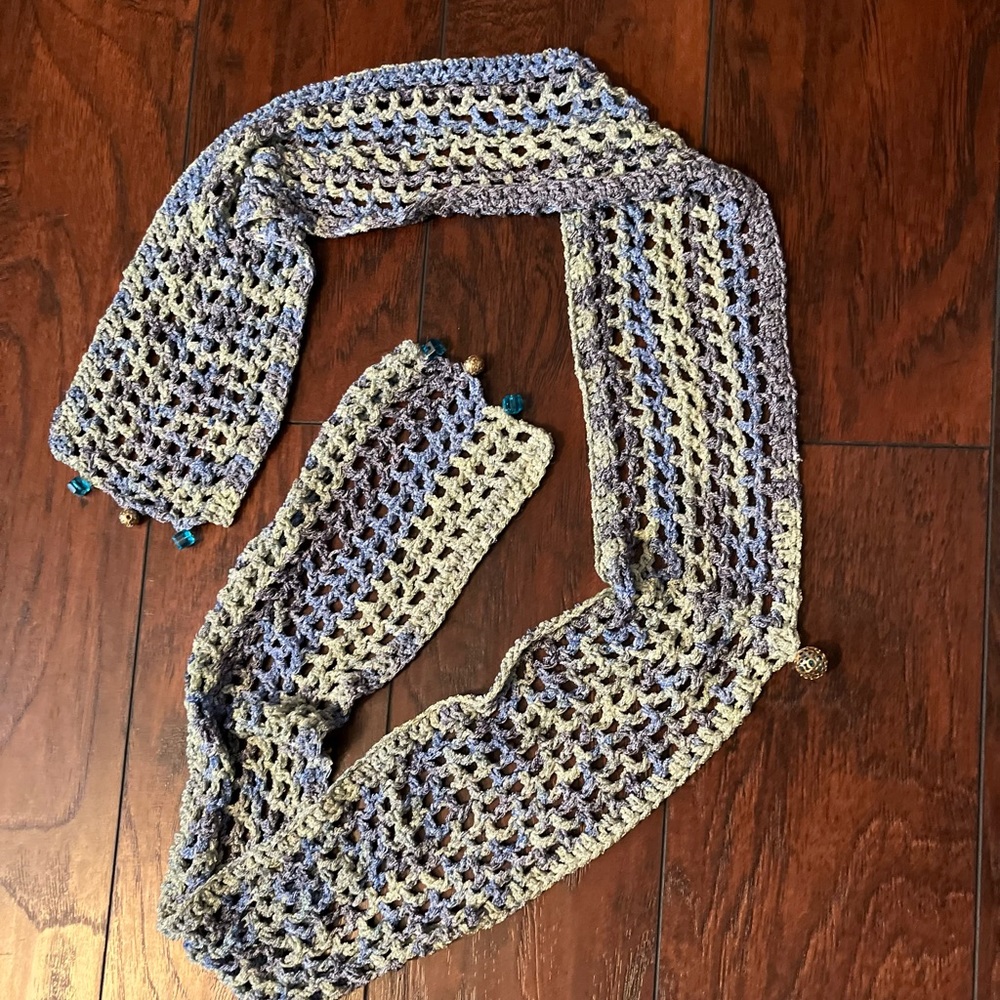 Homemade crocheted scarf with jewels.